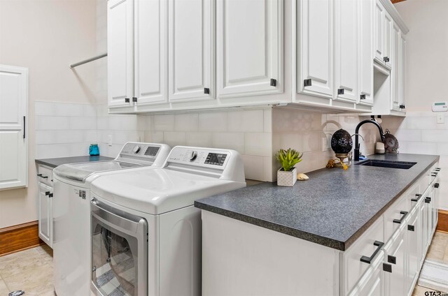 laundry room with washer and dryer, light tile patterned flooring, cabinets, and sink