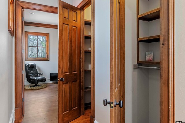 corridor with light hardwood / wood-style flooring