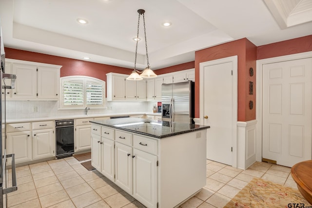 1807 Royal Oak Dr, Tyler, TX 75703 - kitchen featuring stainless steel fridge, a tray ceiling, a center island, light tile patterned floors, and hanging light fixtures