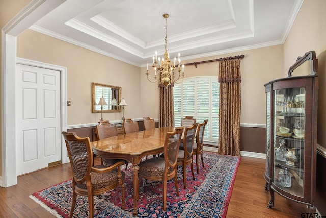 1807 Royal Oak Dr, Tyler, TX 75703 - dining space with a chandelier, wood finished floors, crown molding, and a raised ceiling