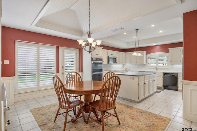 1807 Royal Oak Dr, Tyler, TX 75703 - dining space featuring a tray ceiling, light tile patterned floors, a chandelier, recessed lighting, and wainscoting