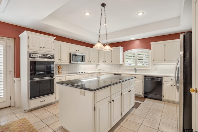 1807 Royal Oak Dr, Tyler, TX 75703 - kitchen with black appliances, a raised ceiling, a kitchen island, light tile patterned floors, and recessed lighting