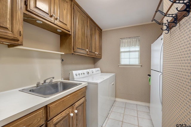 1807 Royal Oak Dr, Tyler, TX 75703 - laundry room with separate washer and dryer, light tile patterned floors, cabinet space, and wallpapered walls