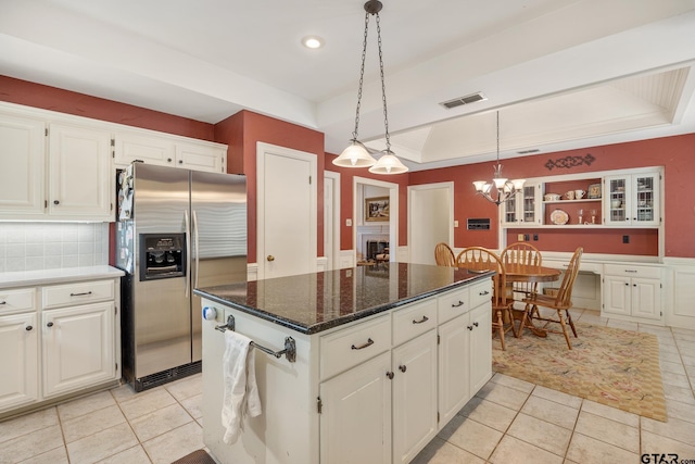 1807 Royal Oak Dr, Tyler, TX 75703 - kitchen with stainless steel fridge with ice dispenser, light tile patterned floors, a raised ceiling, white cabinetry, and recessed lighting