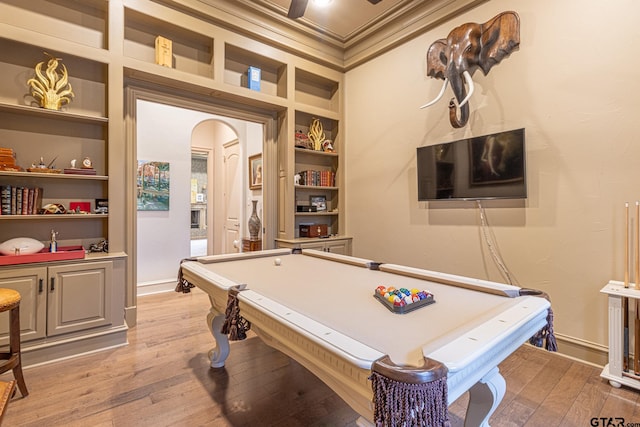 recreation room with built in features, hardwood / wood-style flooring, ornamental molding, and billiards