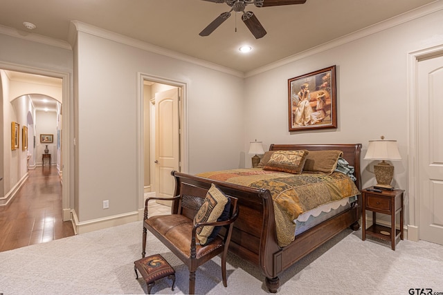 bedroom featuring wood-type flooring, ceiling fan, and crown molding