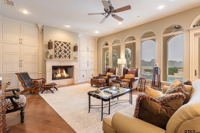 living room featuring light hardwood / wood-style floors and ceiling fan