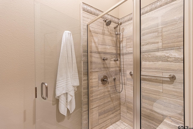 bathroom with a shower with shower door