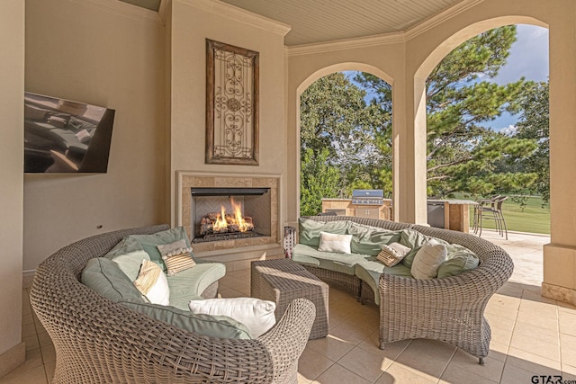 view of patio / terrace featuring area for grilling and an outdoor living space with a fireplace