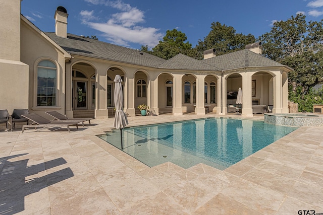 view of pool with an in ground hot tub and a patio area