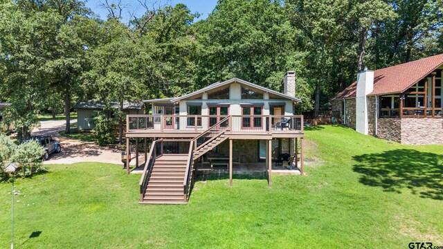 back of property featuring a deck and a yard