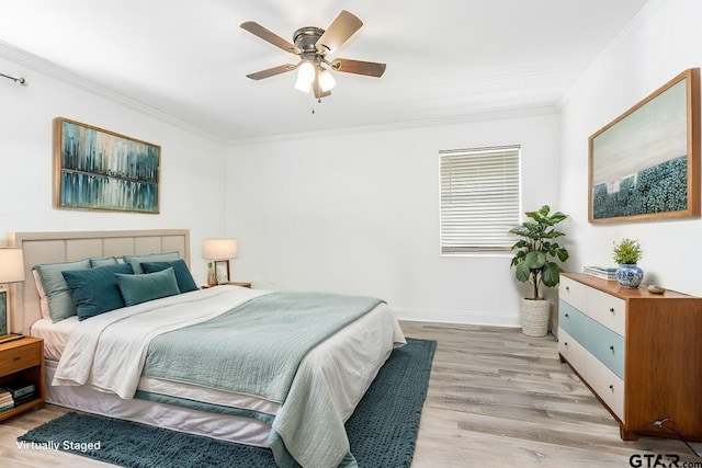 bedroom with ceiling fan, ornamental molding, and light hardwood / wood-style floors