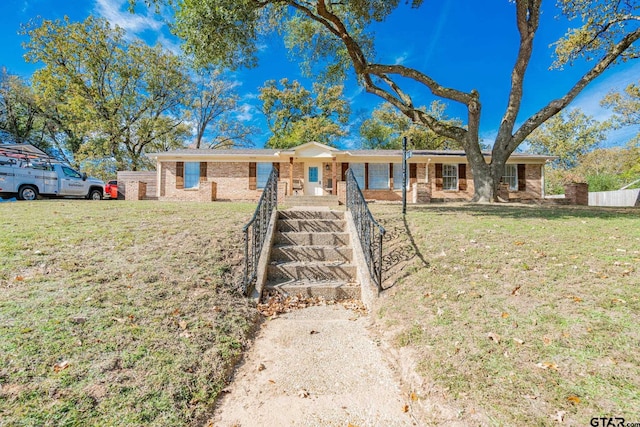 ranch-style home with a front lawn