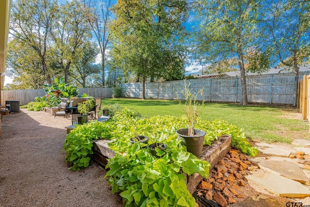 view of yard with central AC and a patio area