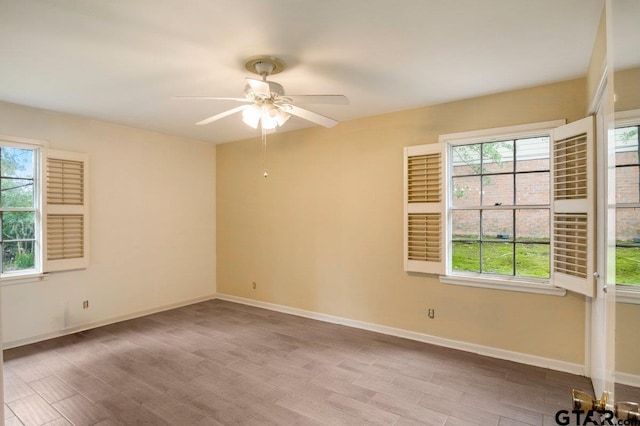3316 Lynnwood Dr, Tyler, TX 75701 - unfurnished room featuring plenty of natural light, wood finished floors, a ceiling fan, and baseboards