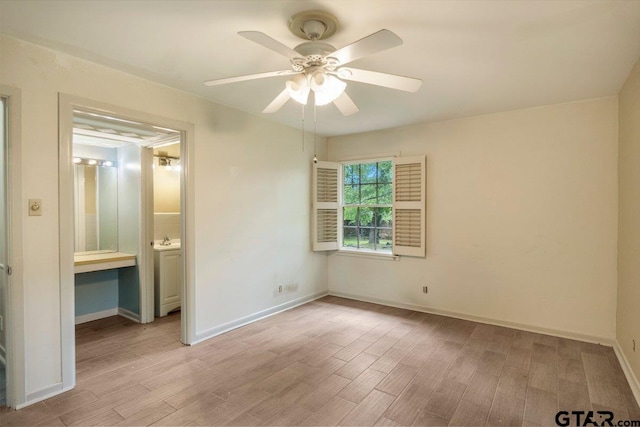 3316 Lynnwood Dr, Tyler, TX 75701 - unfurnished bedroom with wood finished floors, baseboards, ceiling fan, and ensuite bathroom