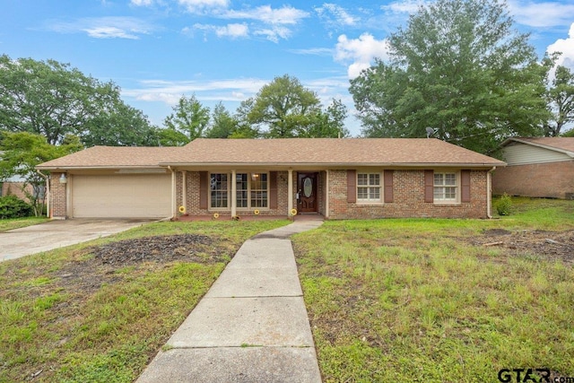 3316 Lynnwood Dr, Tyler, TX 75701 - ranch-style house featuring a garage, concrete driveway, and brick siding