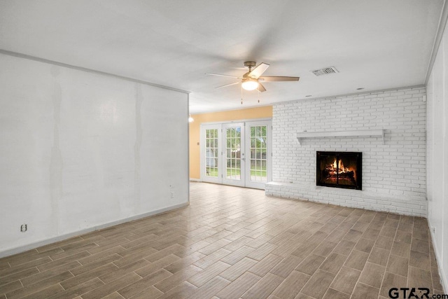3316 Lynnwood Dr, Tyler, TX 75701 - unfurnished living room featuring ceiling fan, wood finished floors, a brick fireplace, and baseboards