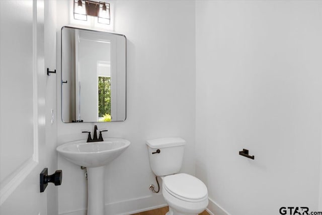 17314 Fm 2767, Tyler, TX 75705 - bathroom featuring baseboards, toilet, and healthy amount of natural light