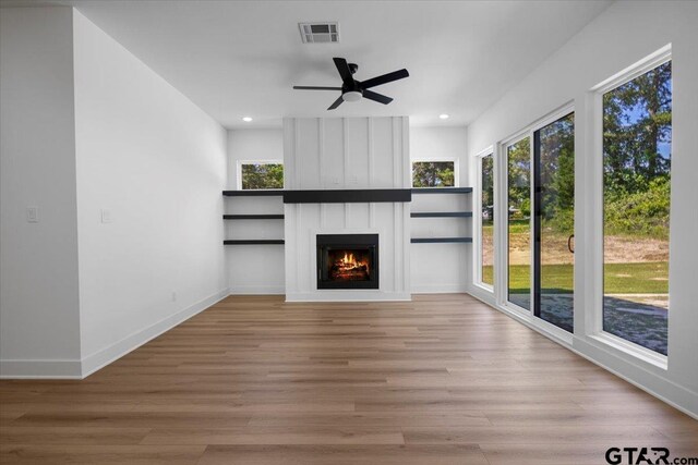17314 Fm 2767, Tyler, TX 75705 - unfurnished living room featuring wood finished floors, recessed lighting, a large fireplace, a ceiling fan, and baseboards