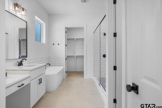 17314 Fm 2767, Tyler, TX 75705 - full bathroom with a shower stall, a freestanding bath, vanity, and a spacious closet