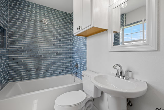 full bath with a sink, toilet, and bathing tub / shower combination