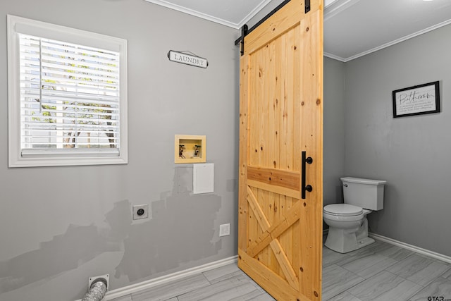 bathroom featuring crown molding, toilet, and baseboards