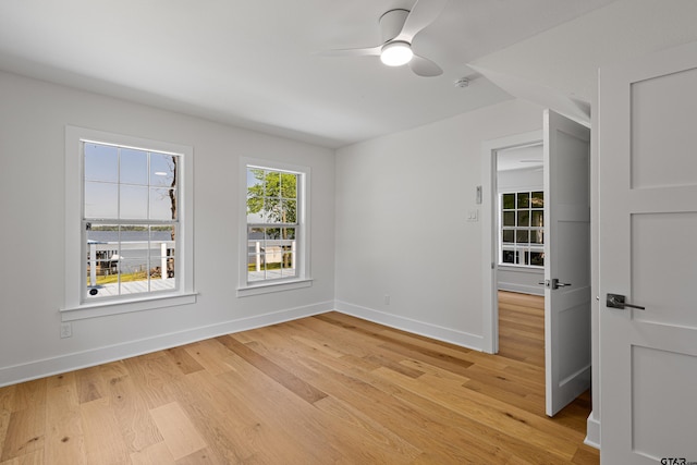 unfurnished room with light wood-type flooring, baseboards, and ceiling fan