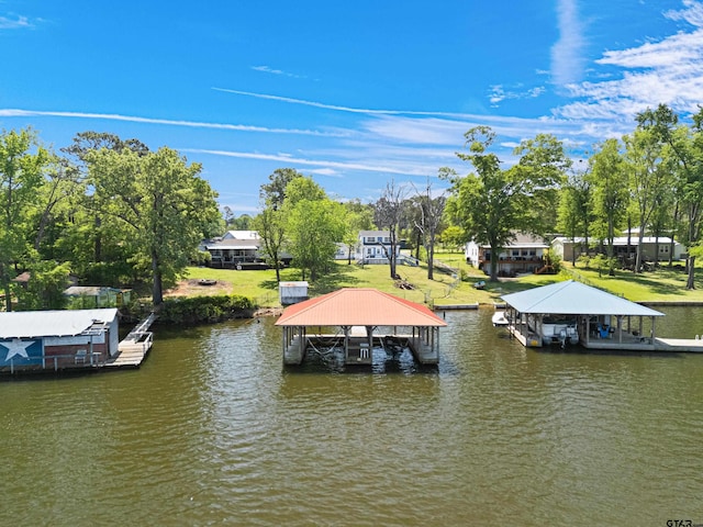 view of dock featuring boat lift, a yard, and a water view