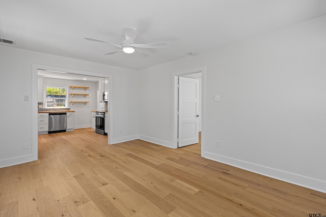 unfurnished living room featuring visible vents, light wood-type flooring, baseboards, and ceiling fan