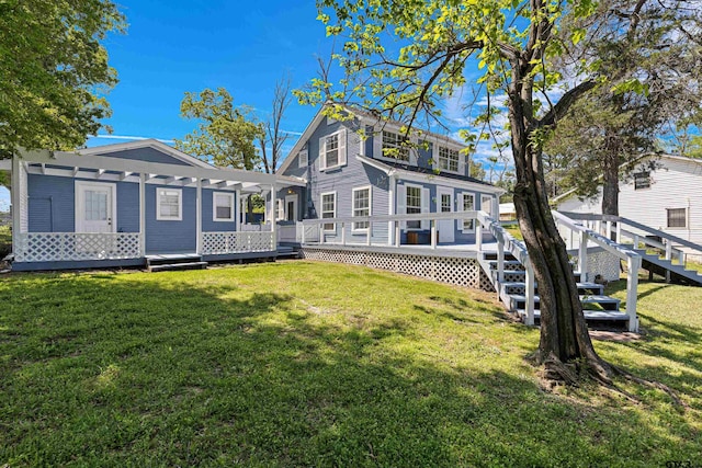 rear view of house with a yard and a deck