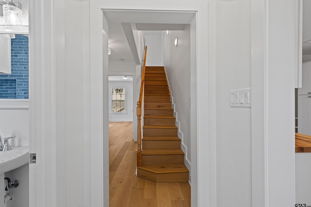 stairs featuring wood-type flooring