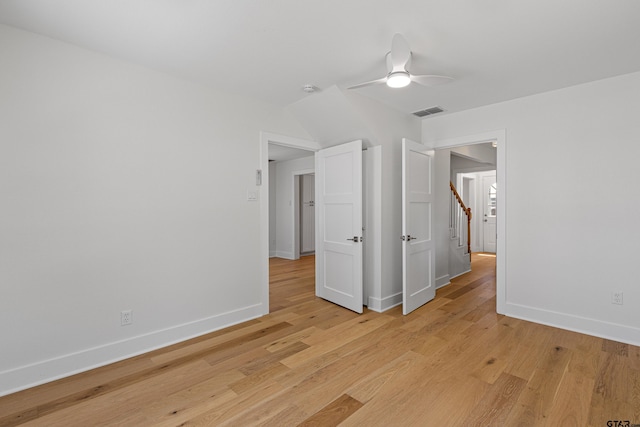 spare room featuring visible vents, baseboards, a ceiling fan, and light wood-style floors