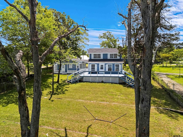 back of house featuring stairway, a wooden deck, fence, and a lawn