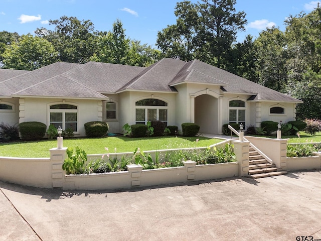 18737 Oakbrook Rd, Tyler, TX 75703 - french country inspired facade with roof with shingles, a front yard, and stucco siding