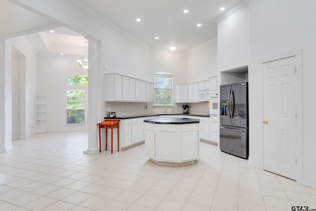 18737 Oakbrook Rd, Tyler, TX 75703 - kitchen featuring white appliances, a towering ceiling, ornamental molding, dark countertops, and recessed lighting