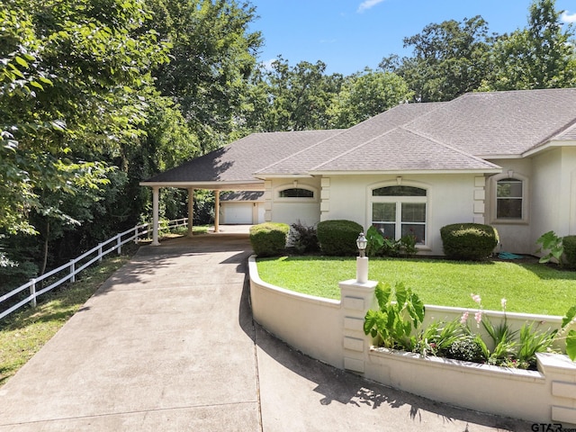 18737 Oakbrook Rd, Tyler, TX 75703 - view of front of house with roof with shingles, concrete driveway, a carport, and stucco siding