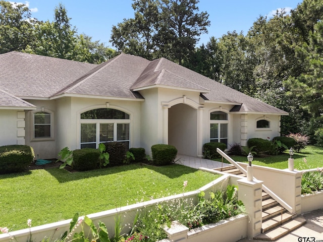 18737 Oakbrook Rd, Tyler, TX 75703 - french country inspired facade with a shingled roof, a front yard, and stucco siding
