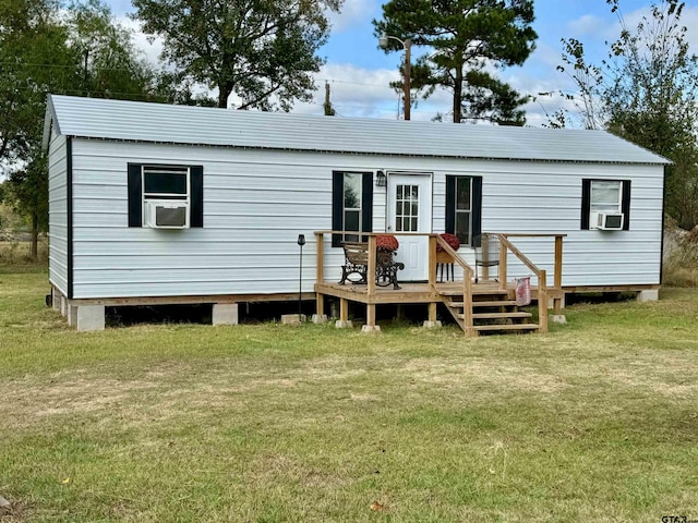 back of house with a deck, a lawn, and cooling unit