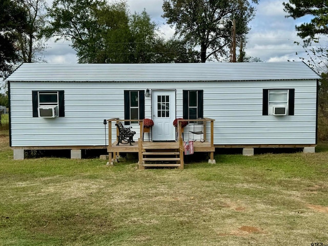 back of house with a deck, cooling unit, and a yard