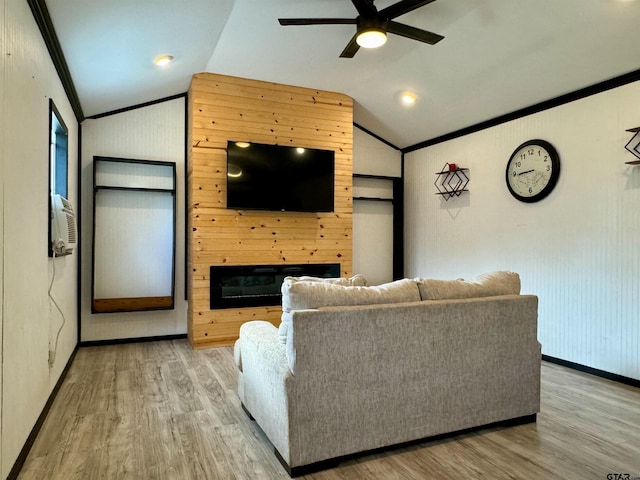 living room featuring ceiling fan, light hardwood / wood-style flooring, lofted ceiling, and ornamental molding