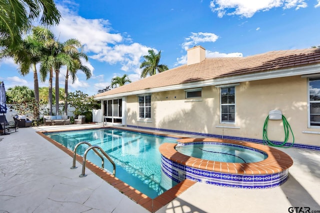 view of pool featuring an in ground hot tub and a patio