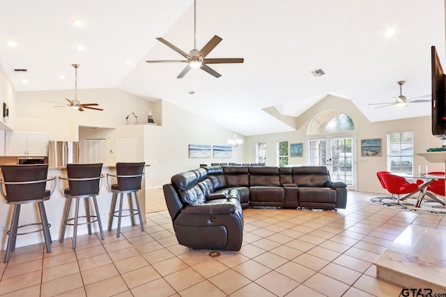 living room with light tile patterned floors, french doors, and lofted ceiling