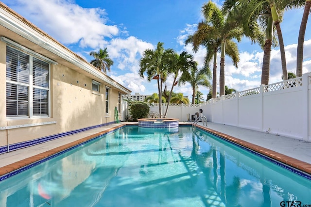 view of pool with an in ground hot tub