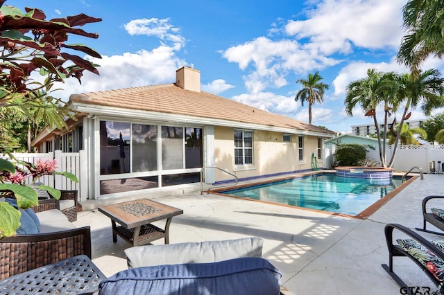 view of pool with an in ground hot tub, a fire pit, and a patio area