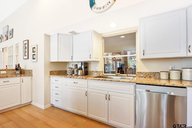 kitchen with dishwasher, white cabinetry, and sink