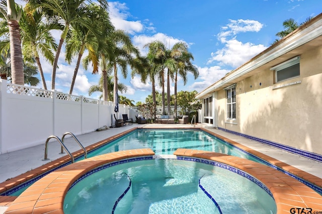 view of swimming pool featuring an in ground hot tub