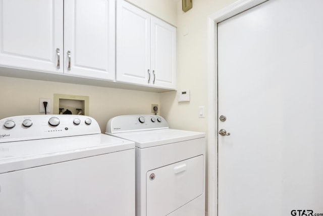 laundry area featuring cabinets and separate washer and dryer