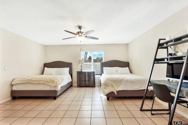 tiled bedroom featuring ceiling fan and a textured ceiling