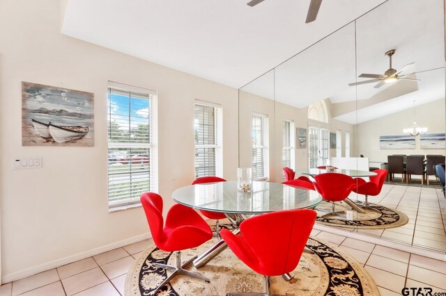 dining room with light tile patterned floors, ceiling fan with notable chandelier, and lofted ceiling